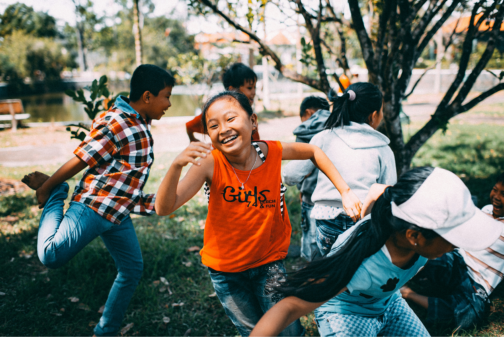 Children enjoying active outdoor play together in a community green space.