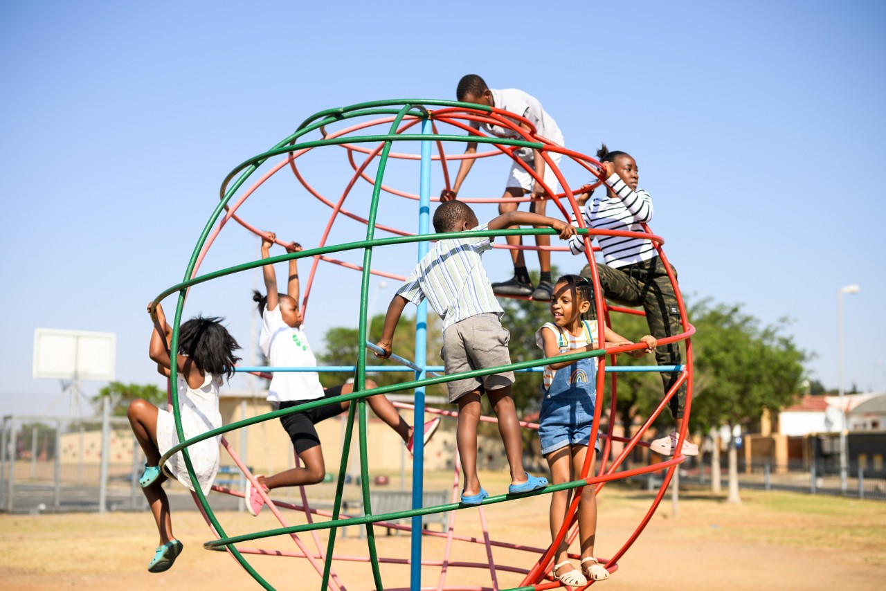 Children playing, eating fruit, socially disadvantaged neighbourhood